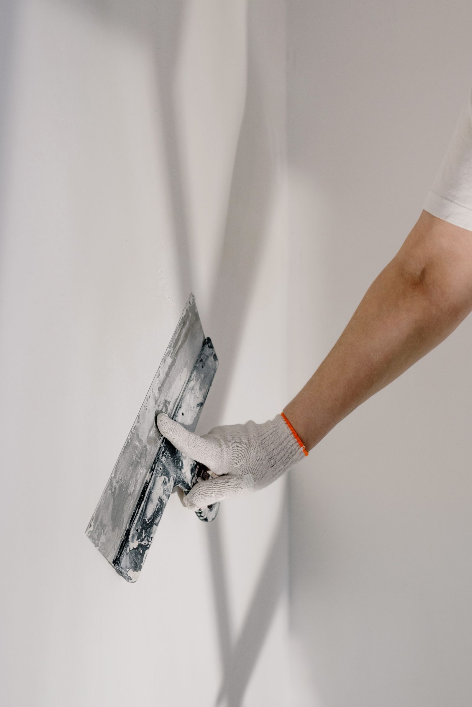 Plasterer working a wall corner with a trowel