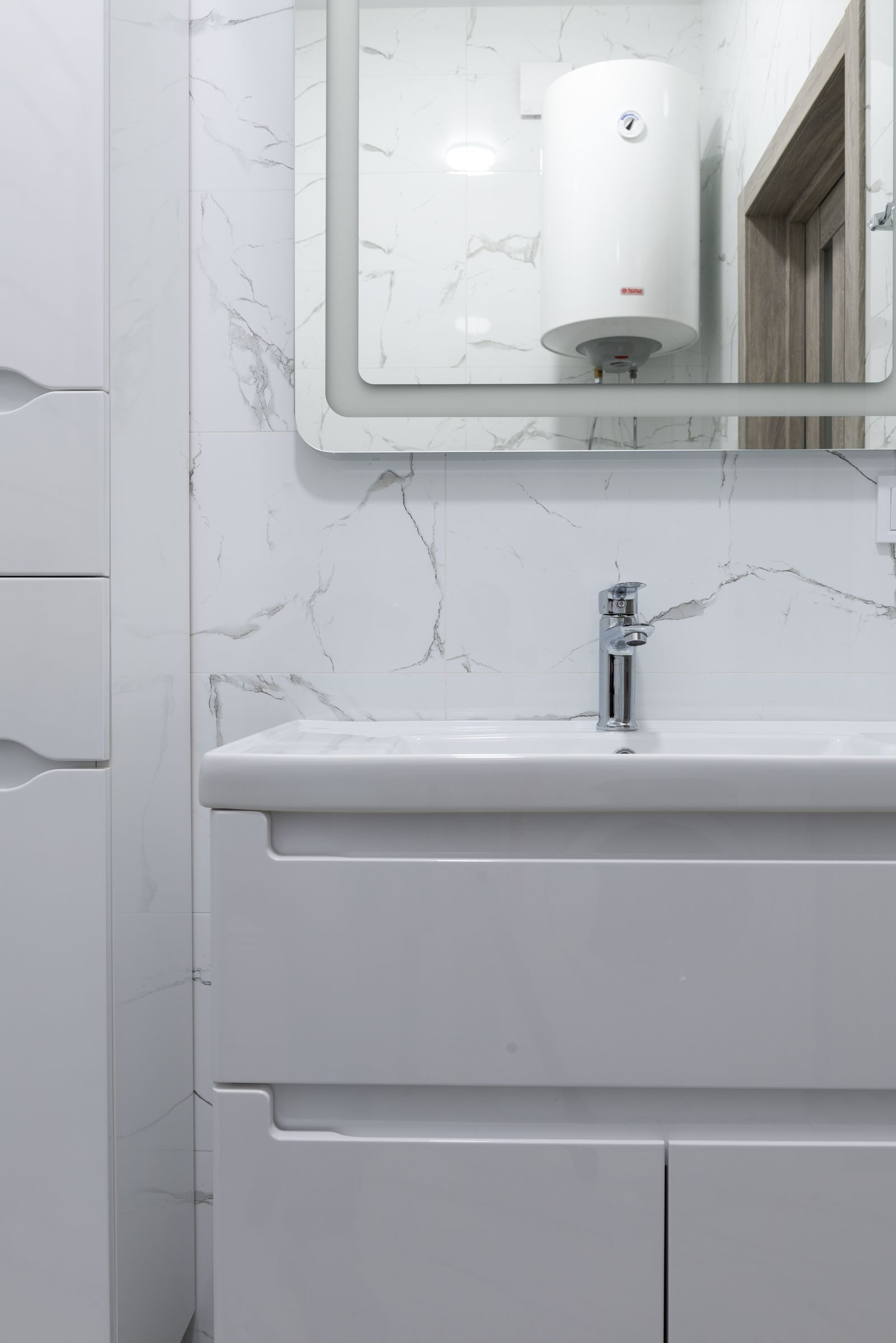 A finished bathroom with a wall-hung basin unit and mirror
