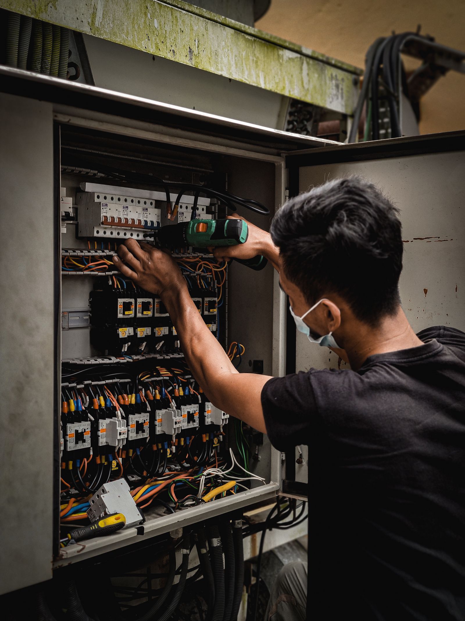 Electrician working inside a distribution board