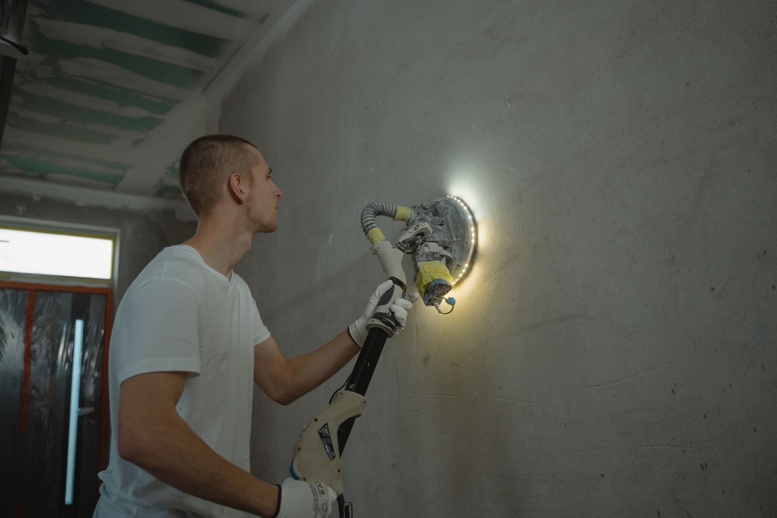 Sanding a wall under work light