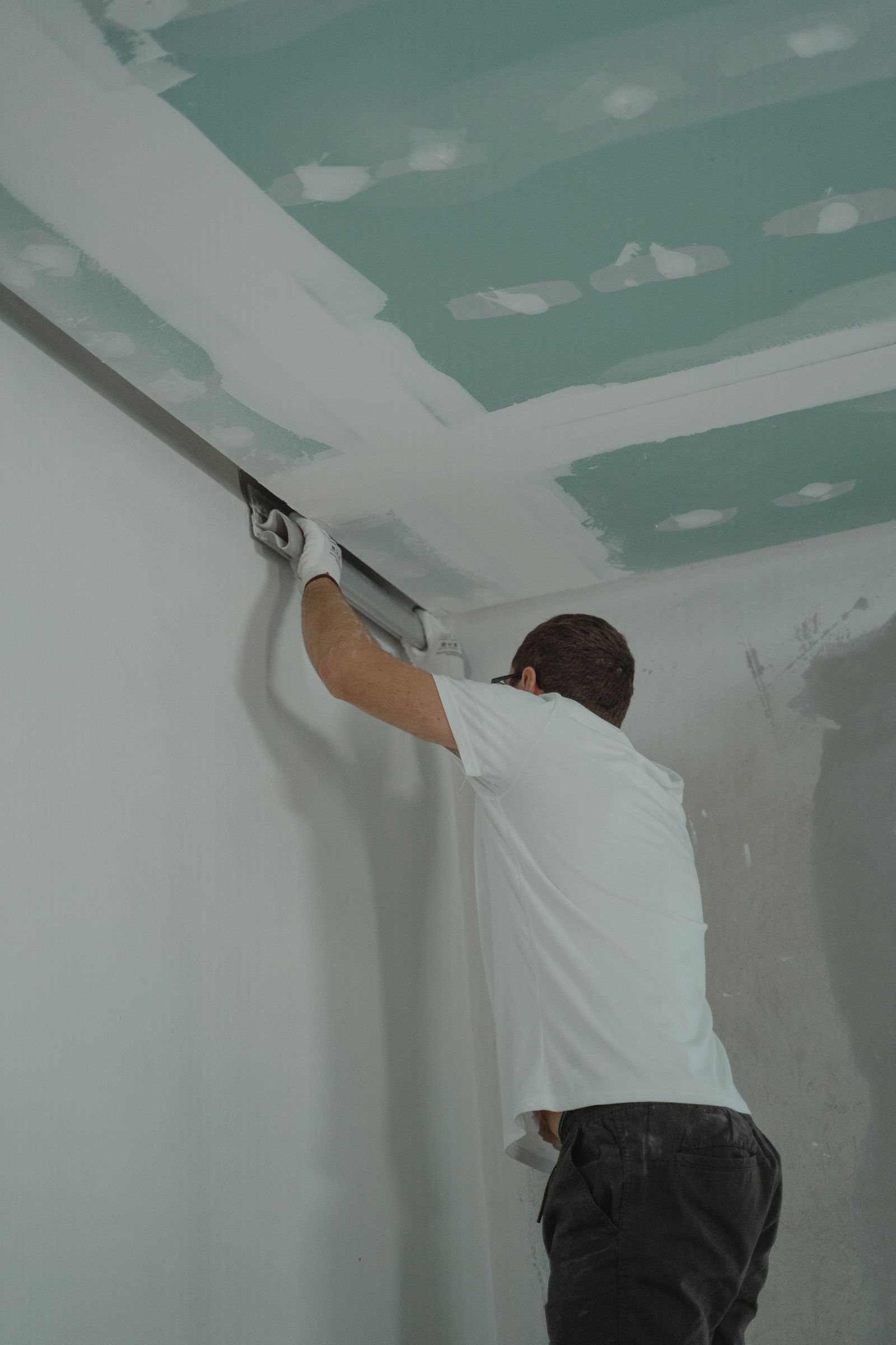 Plasterer skimming a wall by hand
